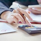 A Dothan wrongful death attorney going over the numbers of a case.