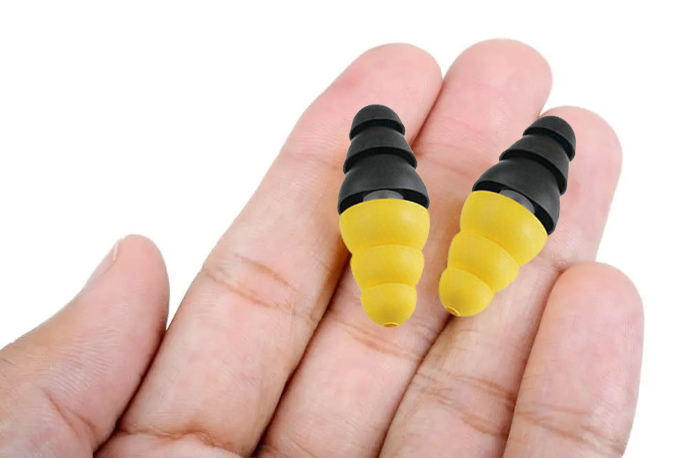 Holding the 3M earplugs.