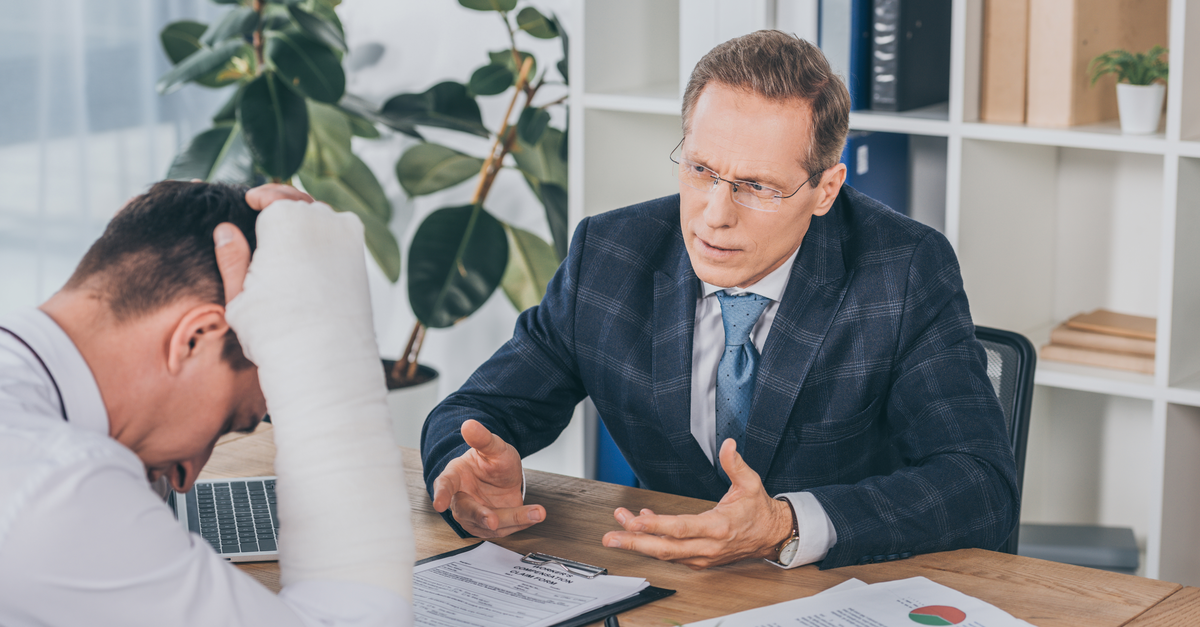 Injured worker consulting workers compensation lawyer..
