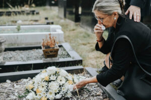 Crying widow on her late husbands funeral.